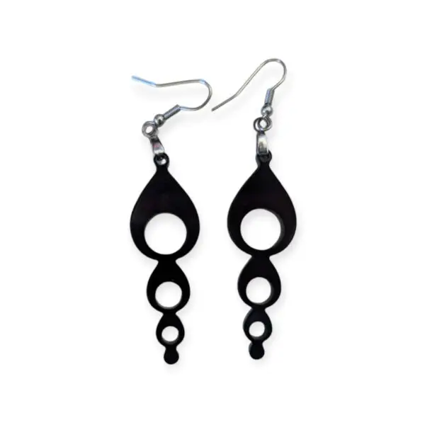 Black Laser Cut Acrylic Bubble Chain Earrings featuring a vertical series of decreasing circular cutouts, creating a bubble chain effect, suspended from silver hooks on a white background.