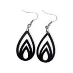 Black Laser Cut Acrylic Flame Drop Earrings with flame-like cutouts, featuring three nested flame shapes inside a teardrop silhouette, hanging from silver hooks against a white background.