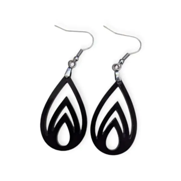 Black Laser Cut Acrylic Flame Drop Earrings with flame-like cutouts, featuring three nested flame shapes inside a teardrop silhouette, hanging from silver hooks against a white background.