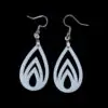 White teardrop-shaped earrings with flame-like cutouts, featuring three nested flame shapes inside a teardrop silhouette, hanging from silver hooks against a black background.