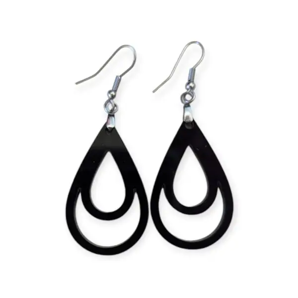 Black Laser Cut Acrylic Double Drop Earrings with two nested teardrop cutouts inside, creating a minimalist geometric effect, hanging from silver hooks against a white background.