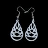 White Celtic knot teardrop earrings made from laser-cut acrylic, featuring intricate interwoven design, hanging from silver-tone hooks on black background.