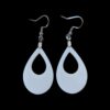 Close-up of white teardrop-shaped acrylic dangle earrings with silver-tone hooks against a black background.