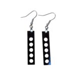 Black rectangular earrings with five circular cutouts arranged vertically, hanging from silver hooks against a white background. Laser Cut Acrylic Grid Earrings.