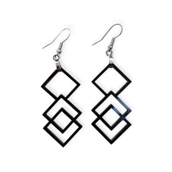 Close-up of black Laser Cut Acrylic Square Earrings featuring three interlocking square shapes, suspended from silvertone surgical steel ear wires against a white background.