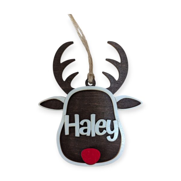 Wooden reindeer-shaped ornament with large antlers and a bright red nose. The name "Haley" is engraved on its face in white text.