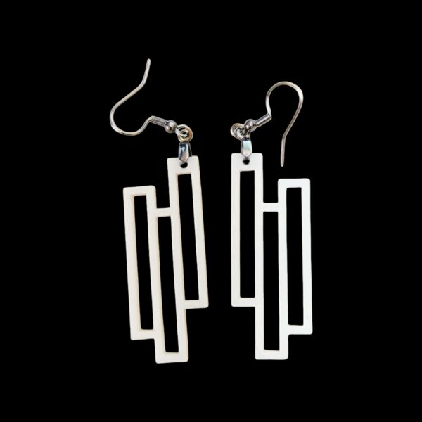 White geometric dangle earrings made from laser-cut acrylic, featuring three interlocking rectangles in a modern, minimalist design.