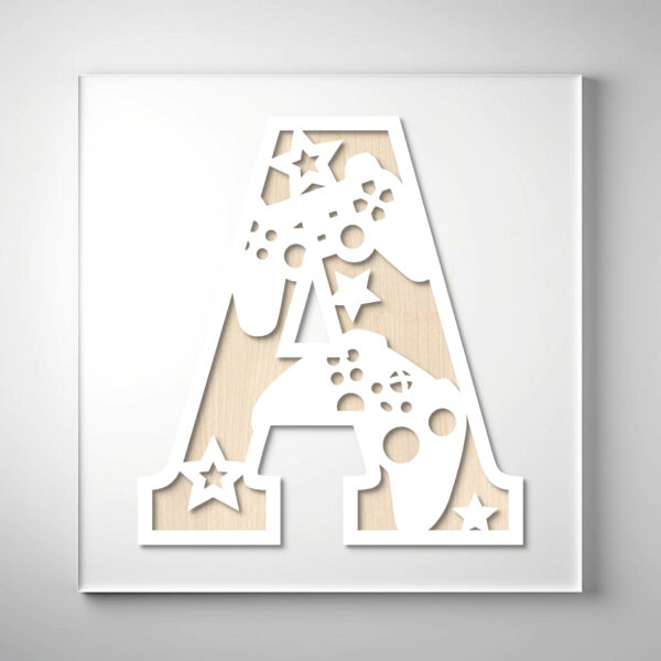 Laser-cut wooden letter "A" featuring video game controllers, stars, and gaming-inspired cutout details over a natural wood grain background.