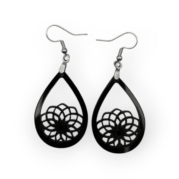 Mandala Madness laser-cut teardrop earrings in black on white background.