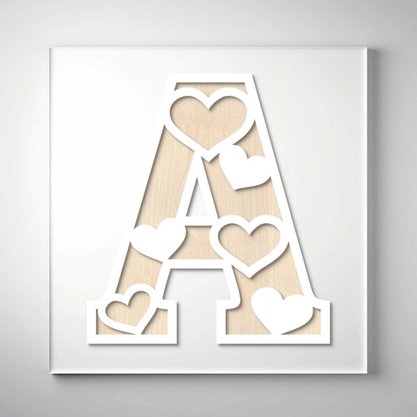 Laser-cut wooden letter "A" featuring heart-shaped cutouts over a natural wood grain background.